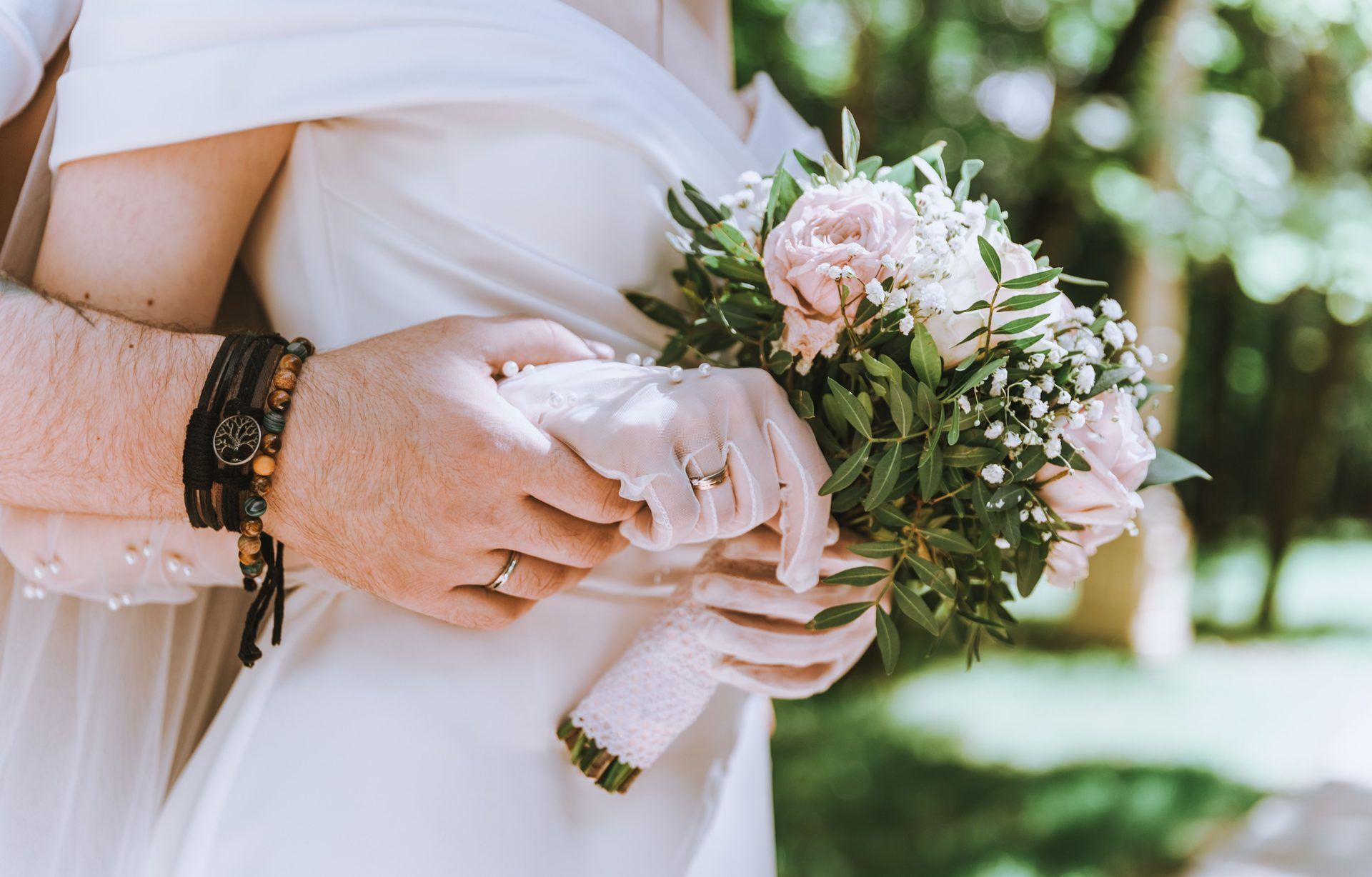 Close-up of the bride's hand with her engagement ring resting on the groom's chest