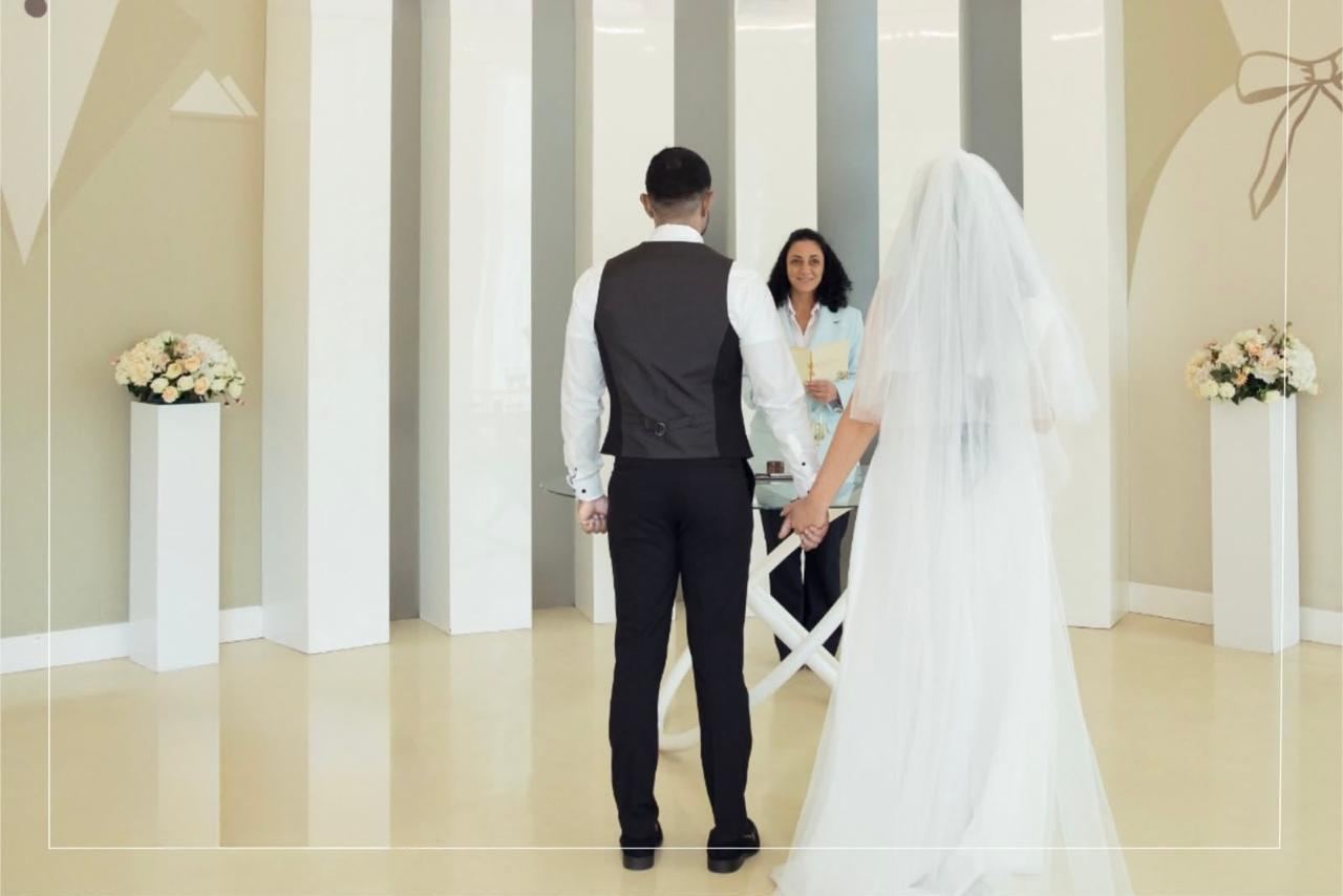 Bride and groom holding hands during their wedding ceremony