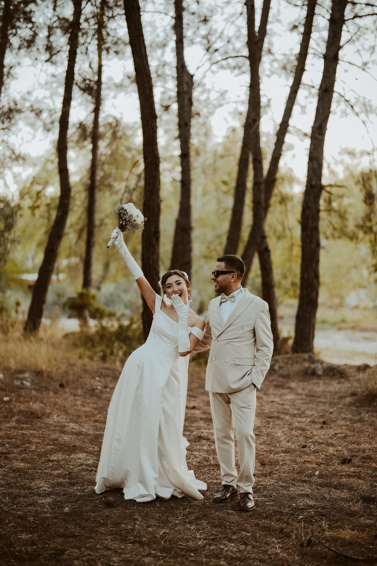 Bride and groom celebrating together in a forest