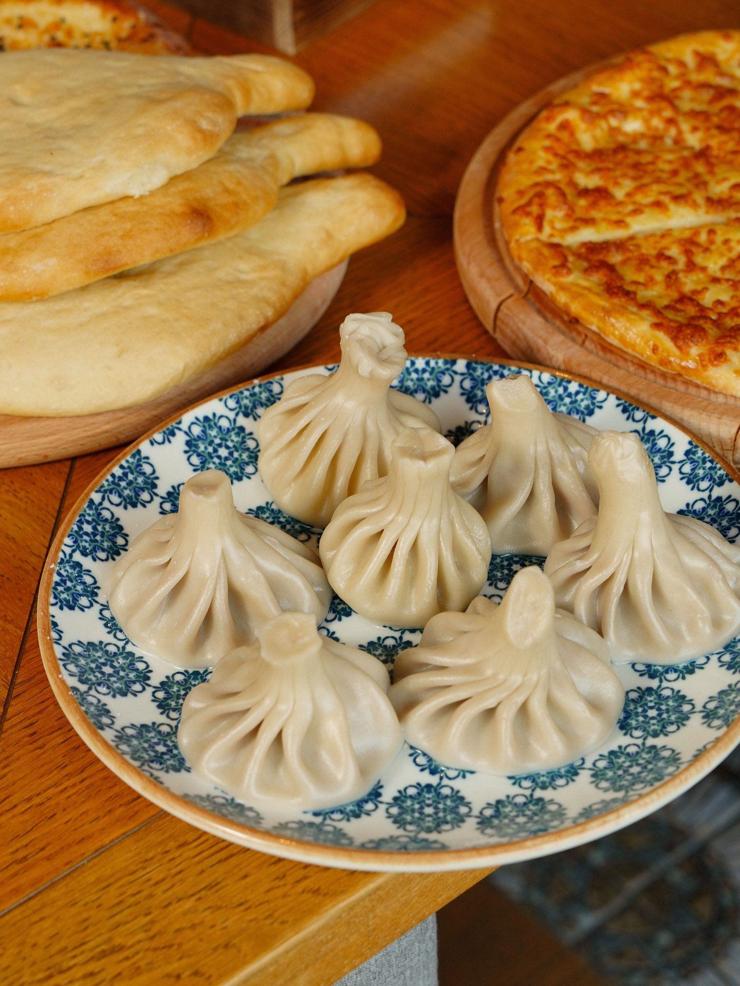 Traditional Georgian khinkali, bread and pizza