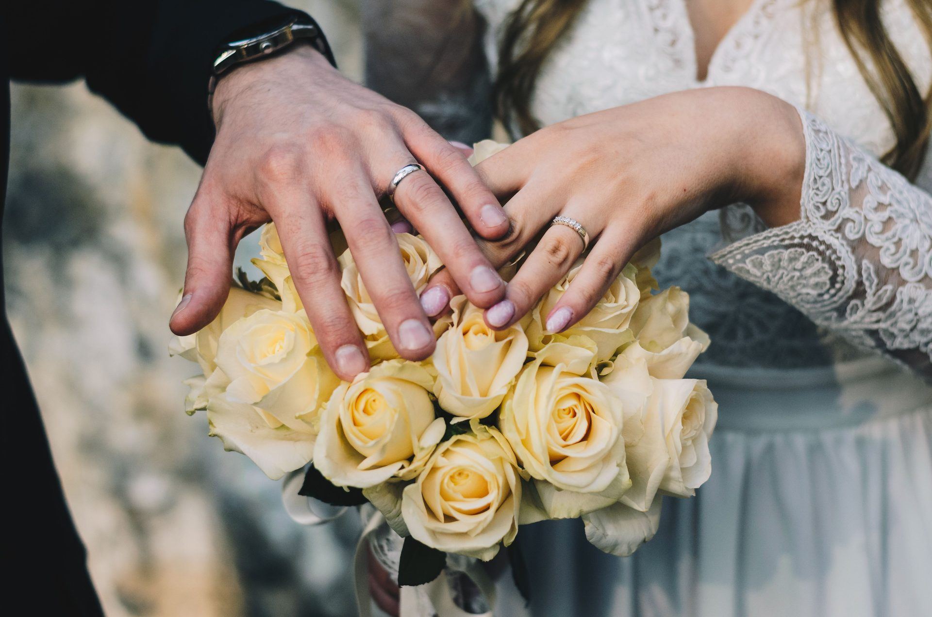 Wedding rings and a bouquet of yellow roses